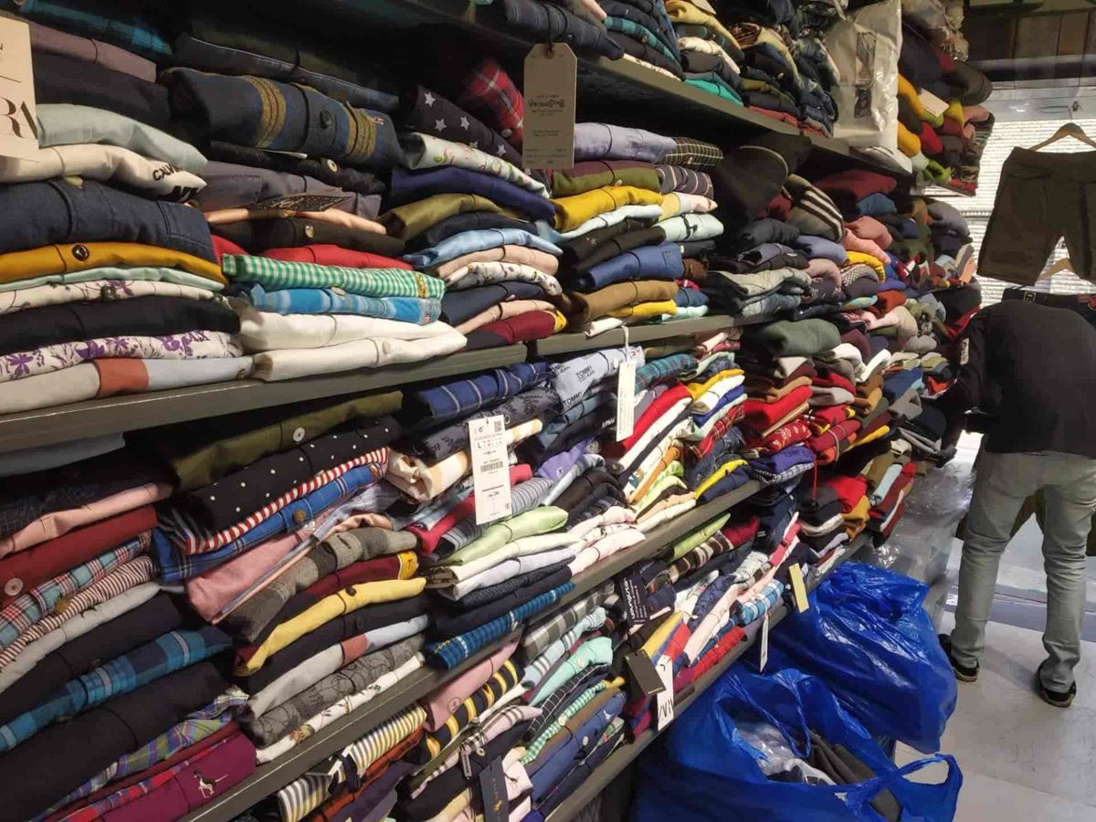 Wall of folded shirts and polos stacked by colour inside Krayons